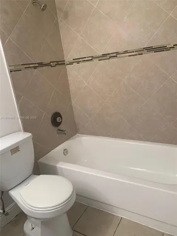 a bathroom with a toilet and a bathtub