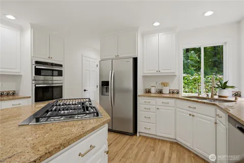 a kitchen with sink a stove and refrigerator