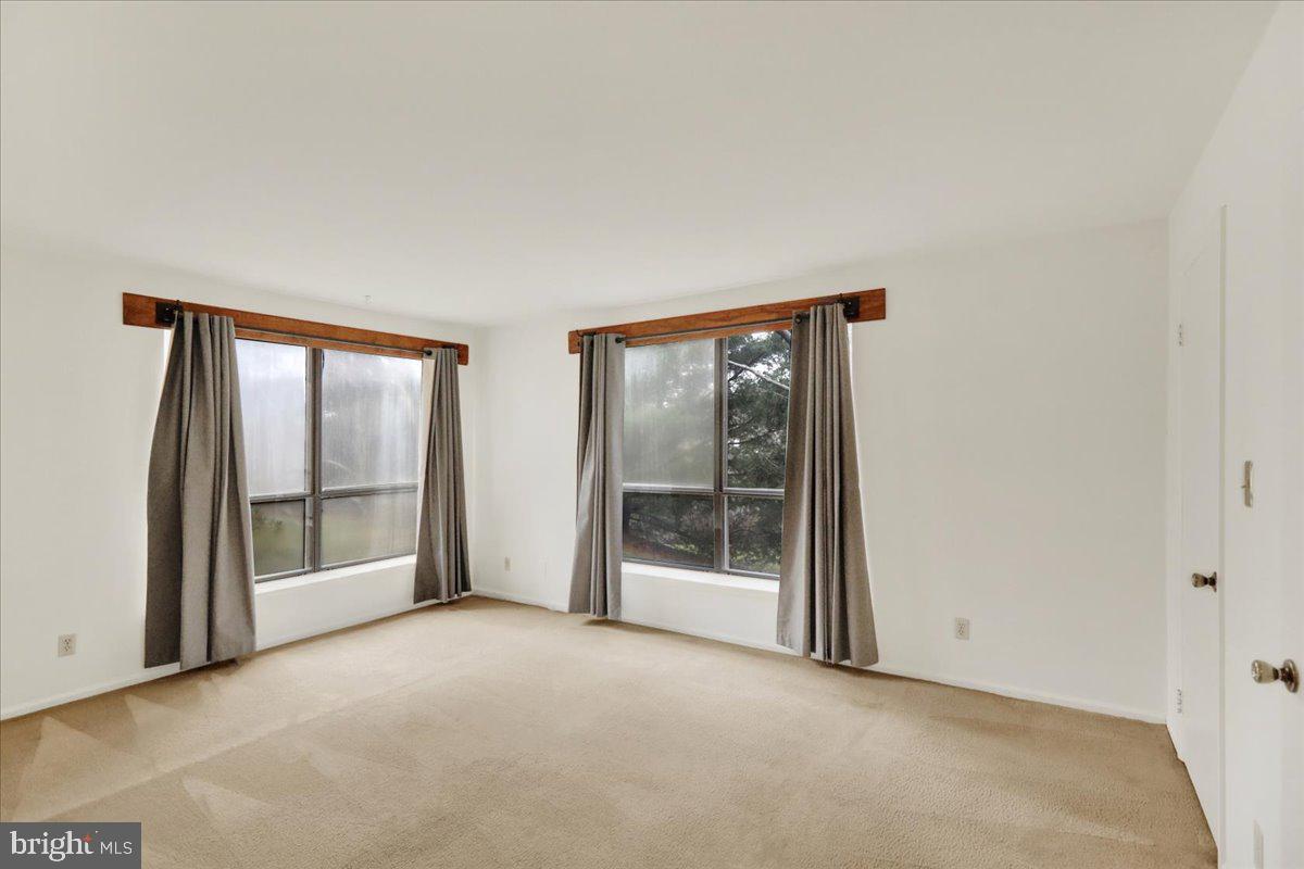 10 D Fairway Road Reading, PA 19607 - Photo 9 of 12 an empty room with wooden floor and windows