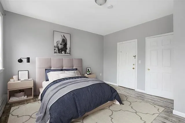 a bedroom with a bed and a painting on the wall