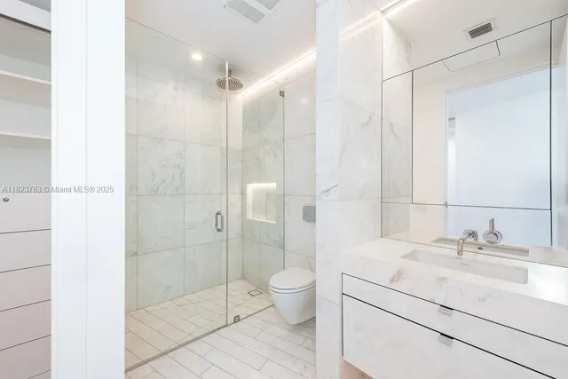 a bathroom with a shower and a sink