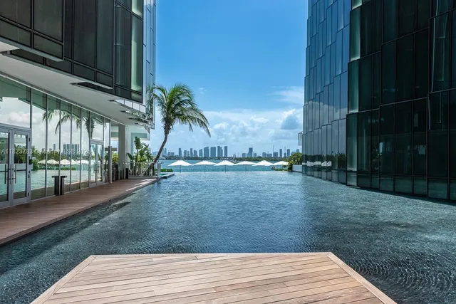 an outdoor sitting area with couch and wooden floor