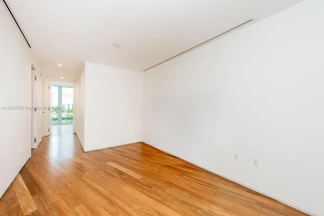 a view of an empty room and glass door