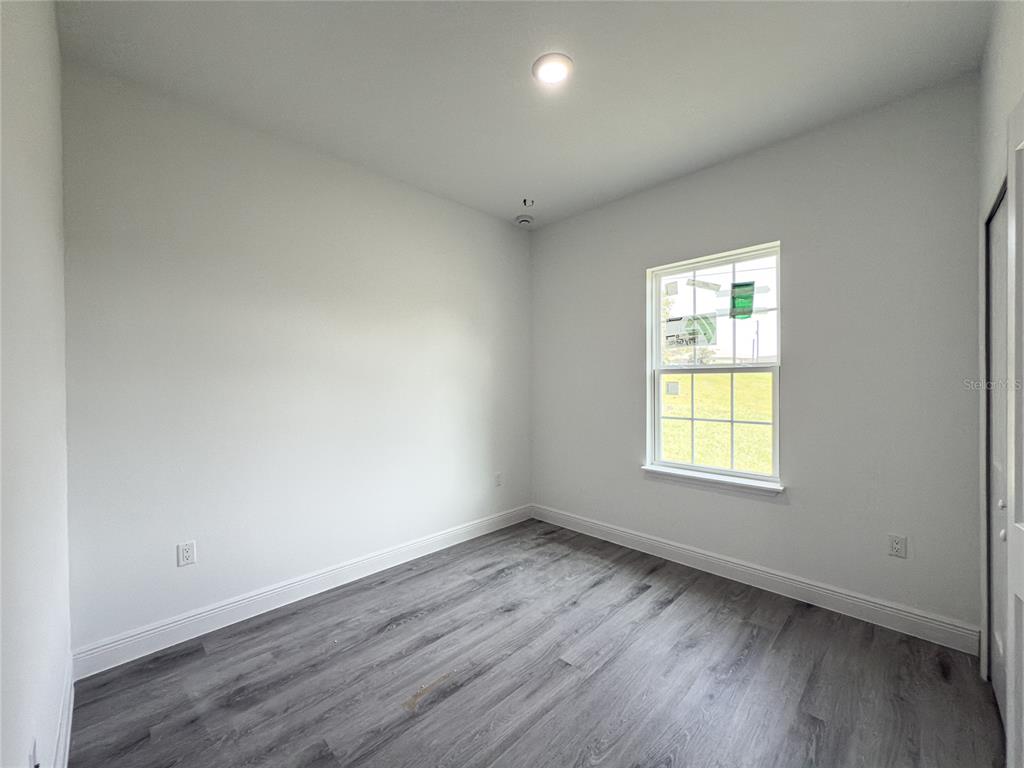 14481 Southwest 29th Terrace Ocala, FL 34473 - Photo 21 of 31 an empty room with wooden floor and windows