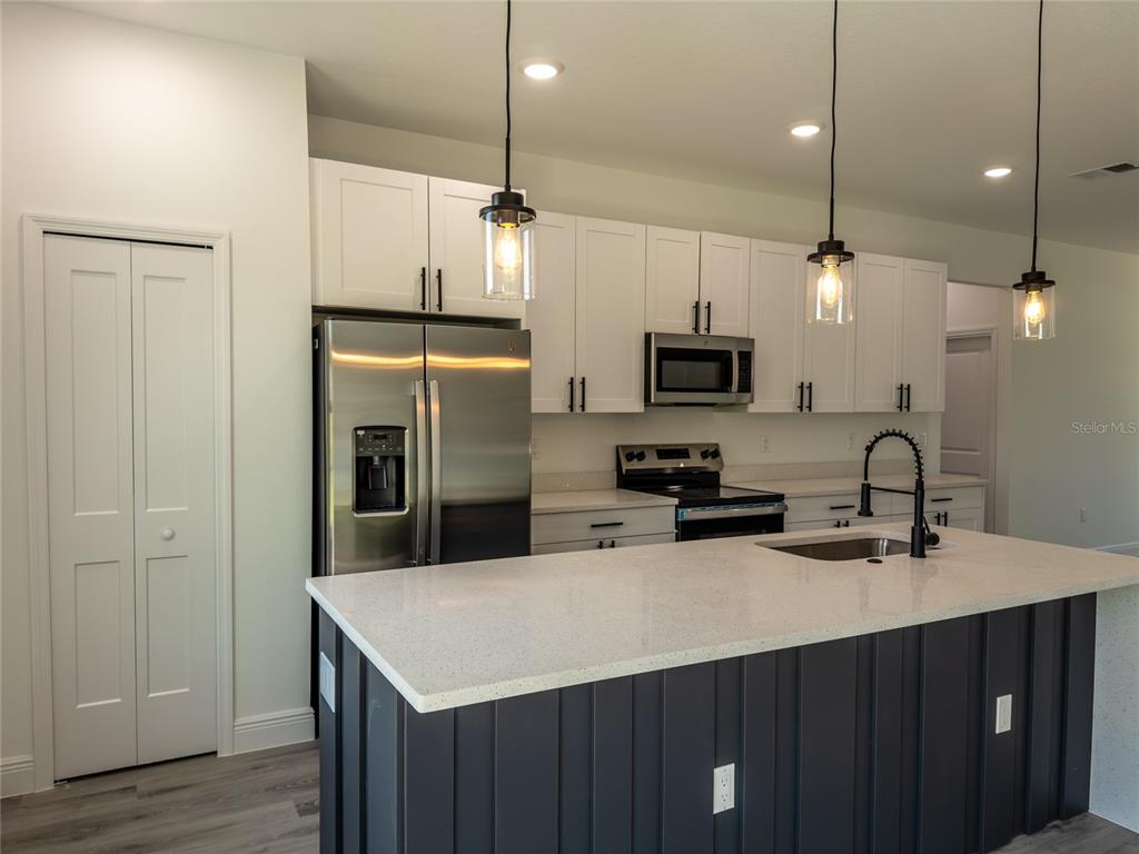 14481 Southwest 29th Terrace Ocala, FL 34473 - Photo 7 of 31 a kitchen with a sink a counter space cabinets and stainless steel appliances