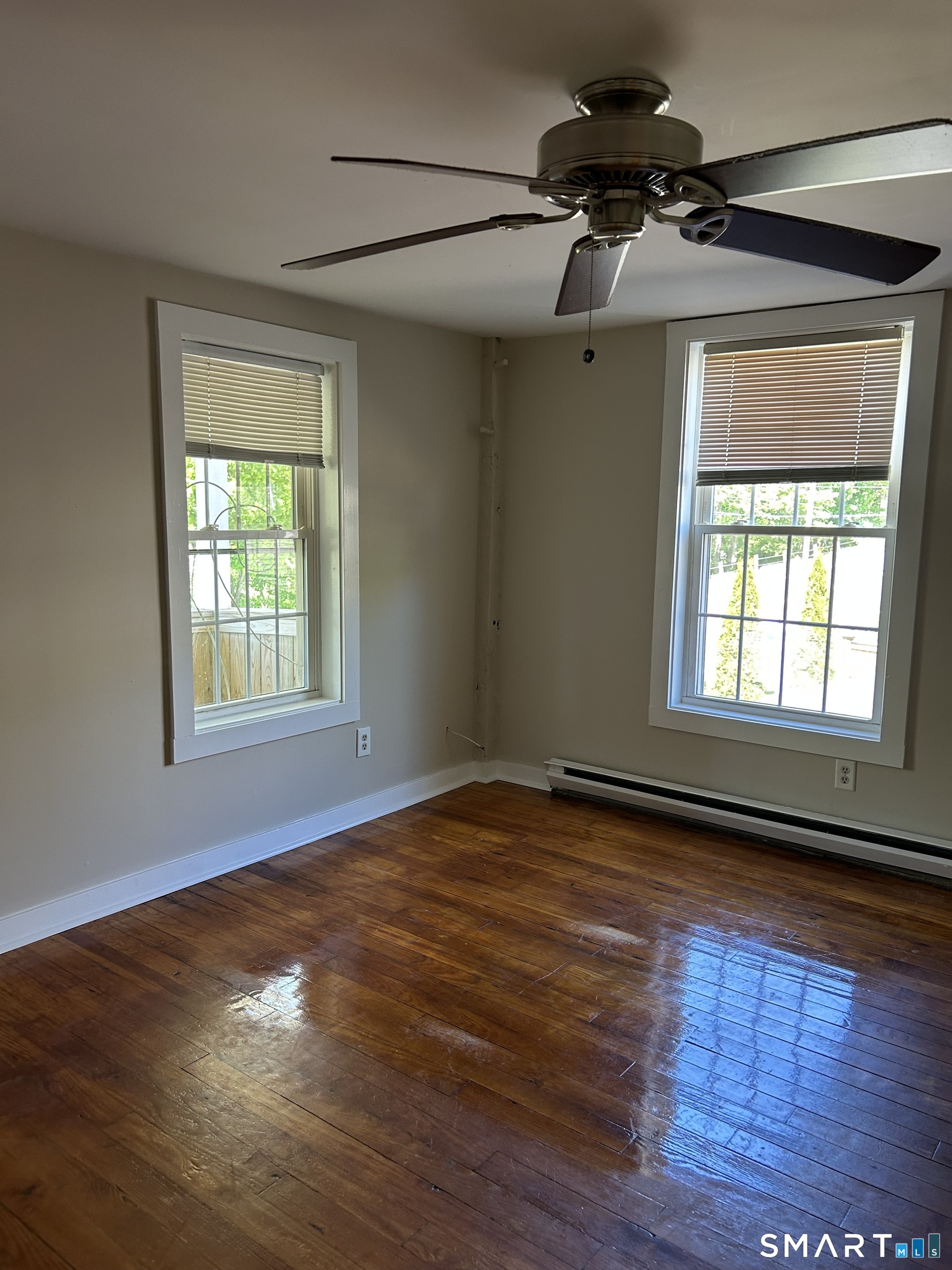 4 Weekeepeemee Road Woodbury, CT 06798 - Photo 13 of 22 a view of an empty room with wooden floor and a window