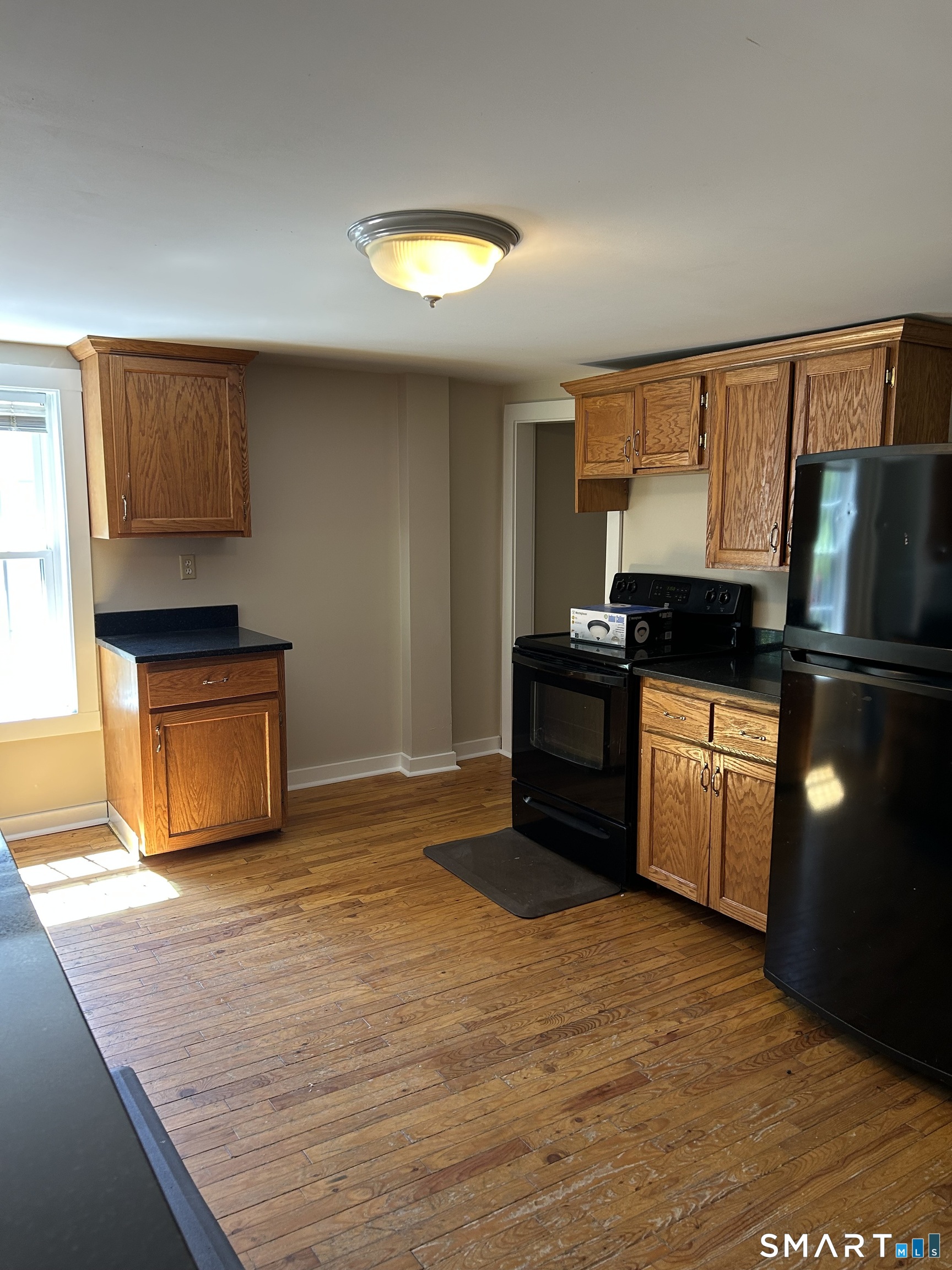 4 Weekeepeemee Road Woodbury, CT 06798 - Photo 3 of 22 a kitchen with granite countertop a stove a sink and a refrigerator