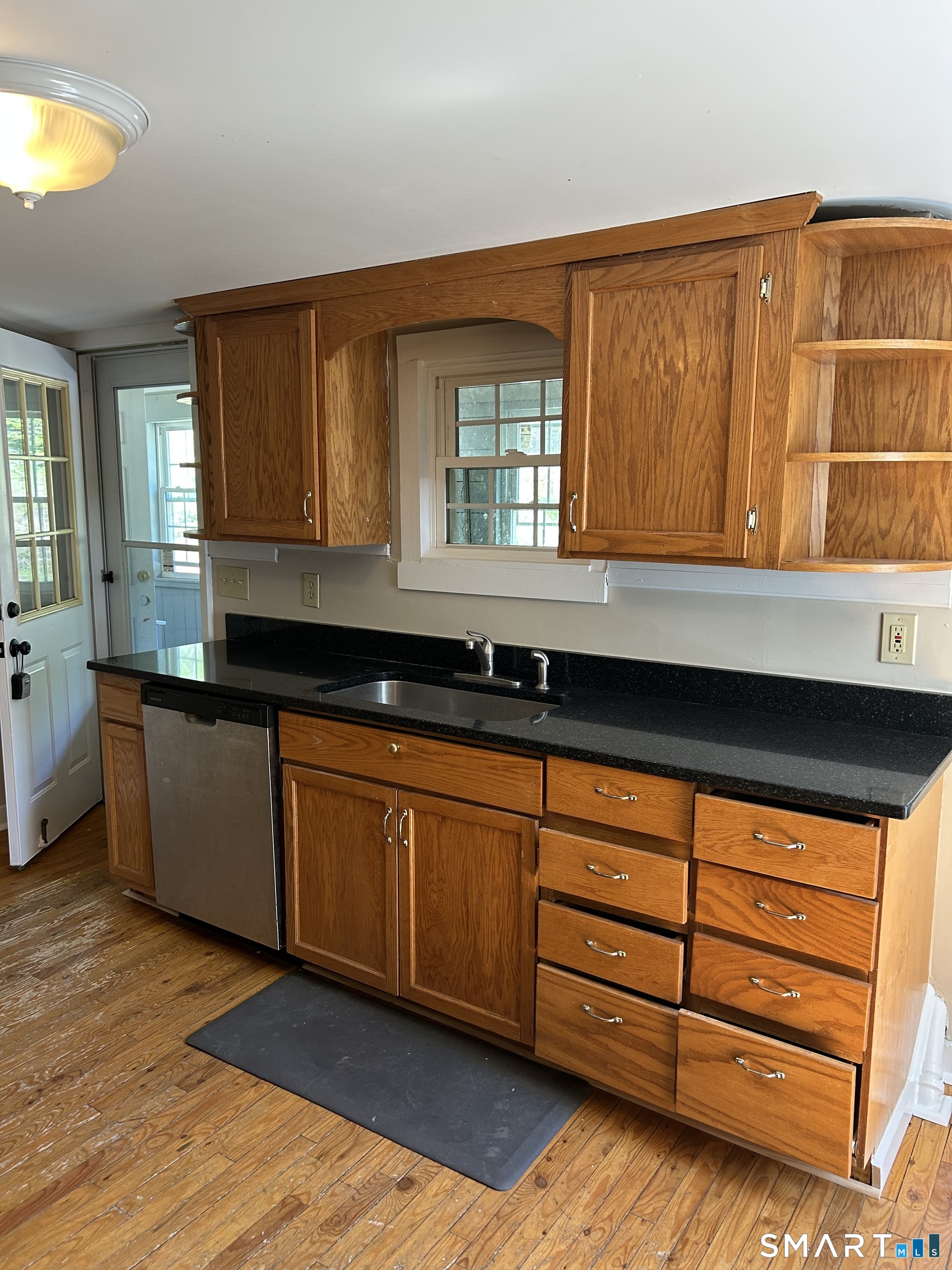 4 Weekeepeemee Road Woodbury, CT 06798 - Photo 4 of 22 a kitchen with granite countertop wooden cabinets a sink and a window
