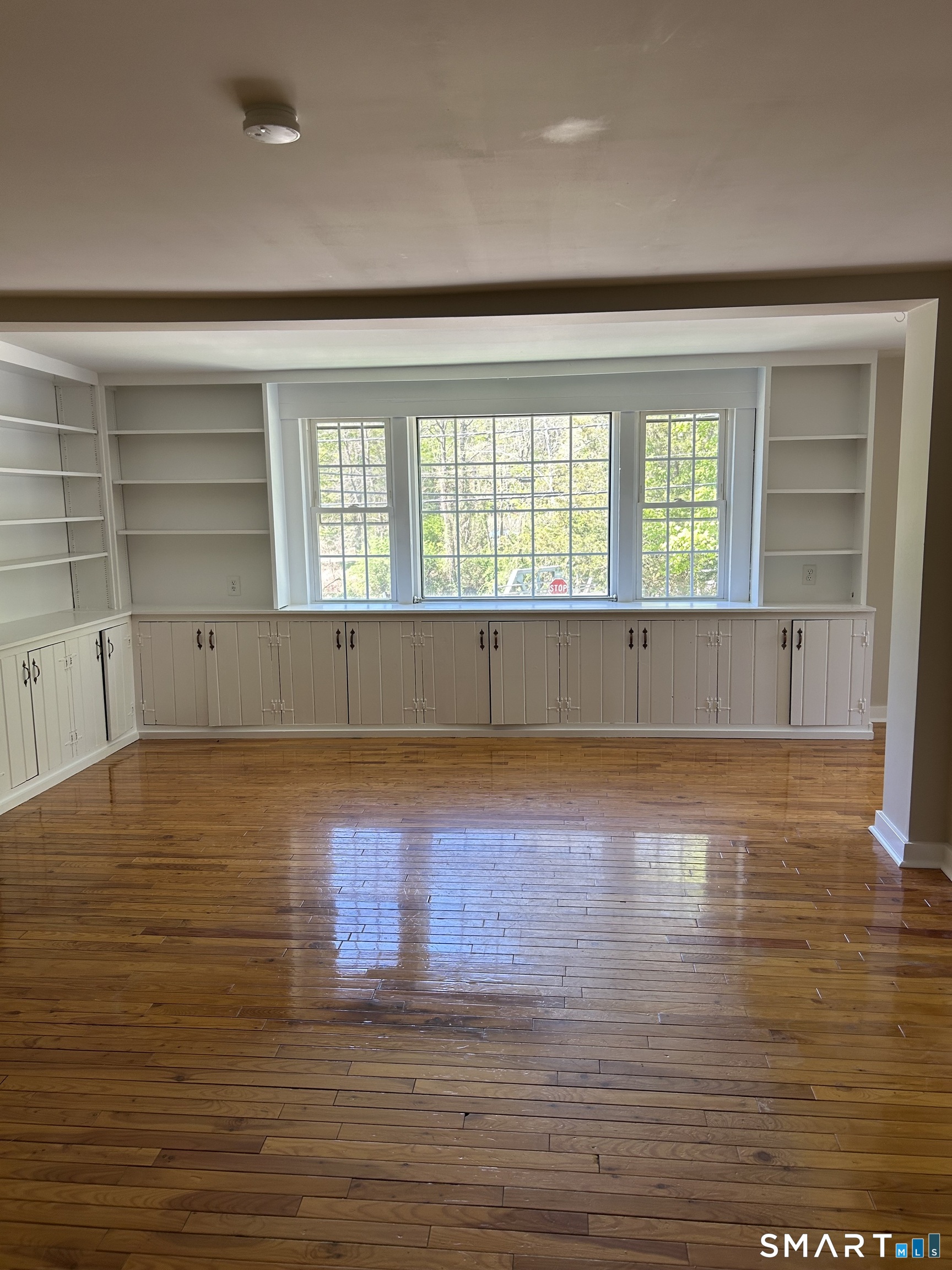 4 Weekeepeemee Road Woodbury, CT 06798 - Photo 8 of 22 an empty room with wooden floor and windows