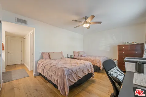 a bedroom with two beds and a chandelier