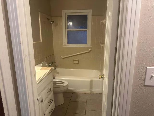 a bathroom with a toilet and a bathtub