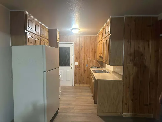 a kitchen with refrigerator and car