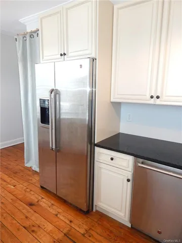 a kitchen with appliances cabinets and a counter top space