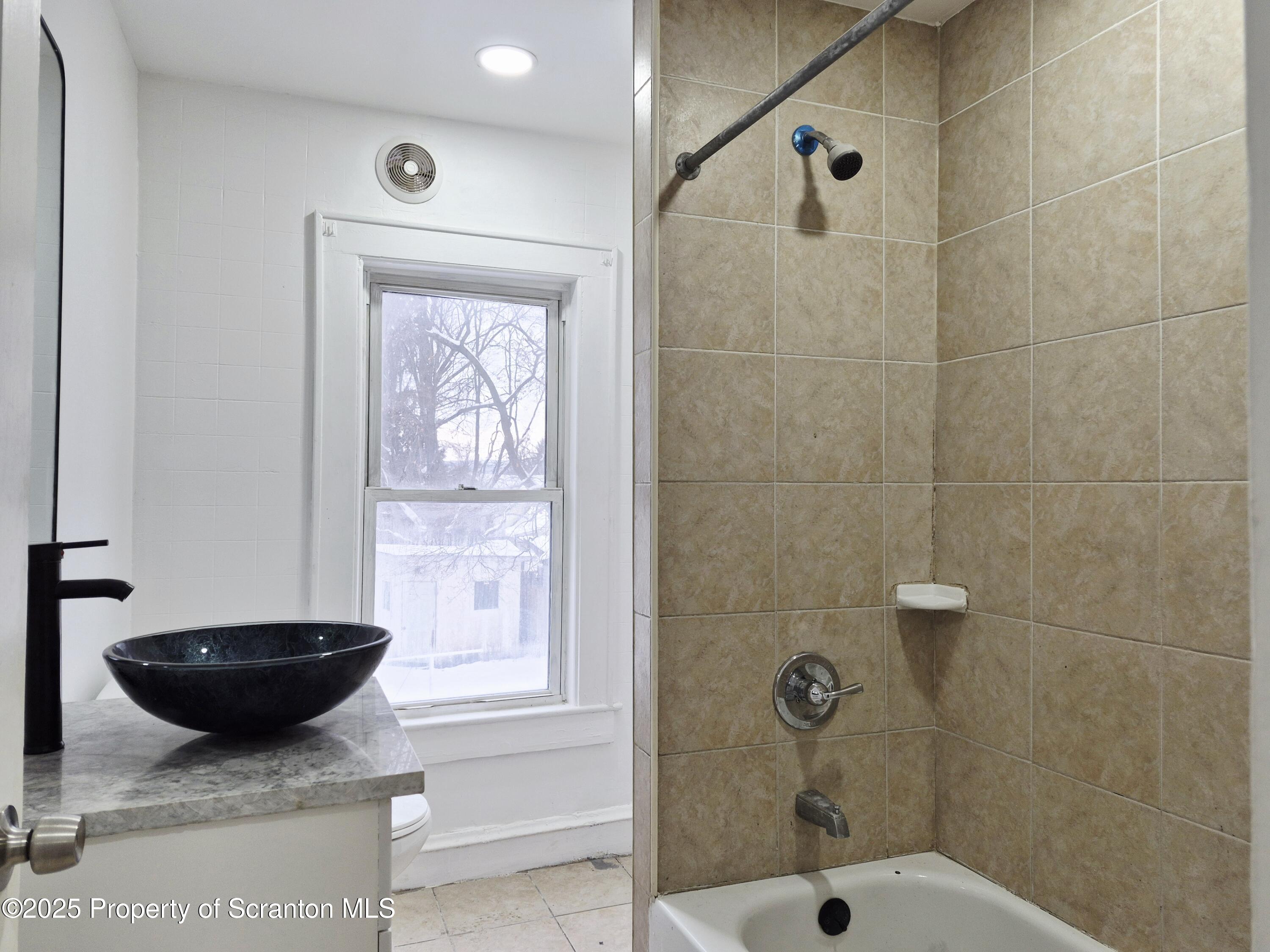1758 Wayne Avenue Scranton, PA 18508 - Photo 15 of 20 a bathroom with a granite countertop sink a window and shower