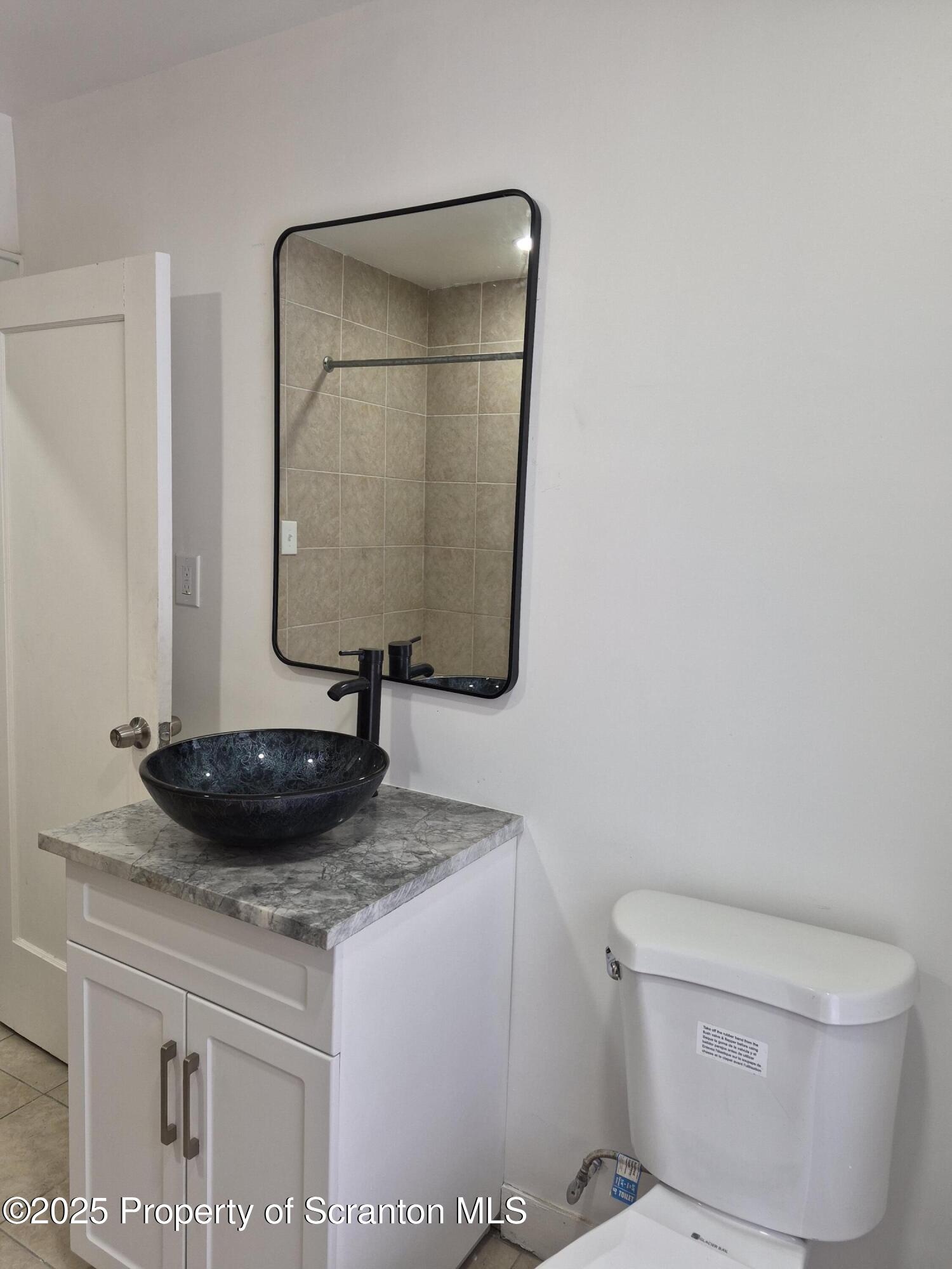 1758 Wayne Avenue Scranton, PA 18508 - Photo 16 of 20 a bathroom with a toilet and a sink