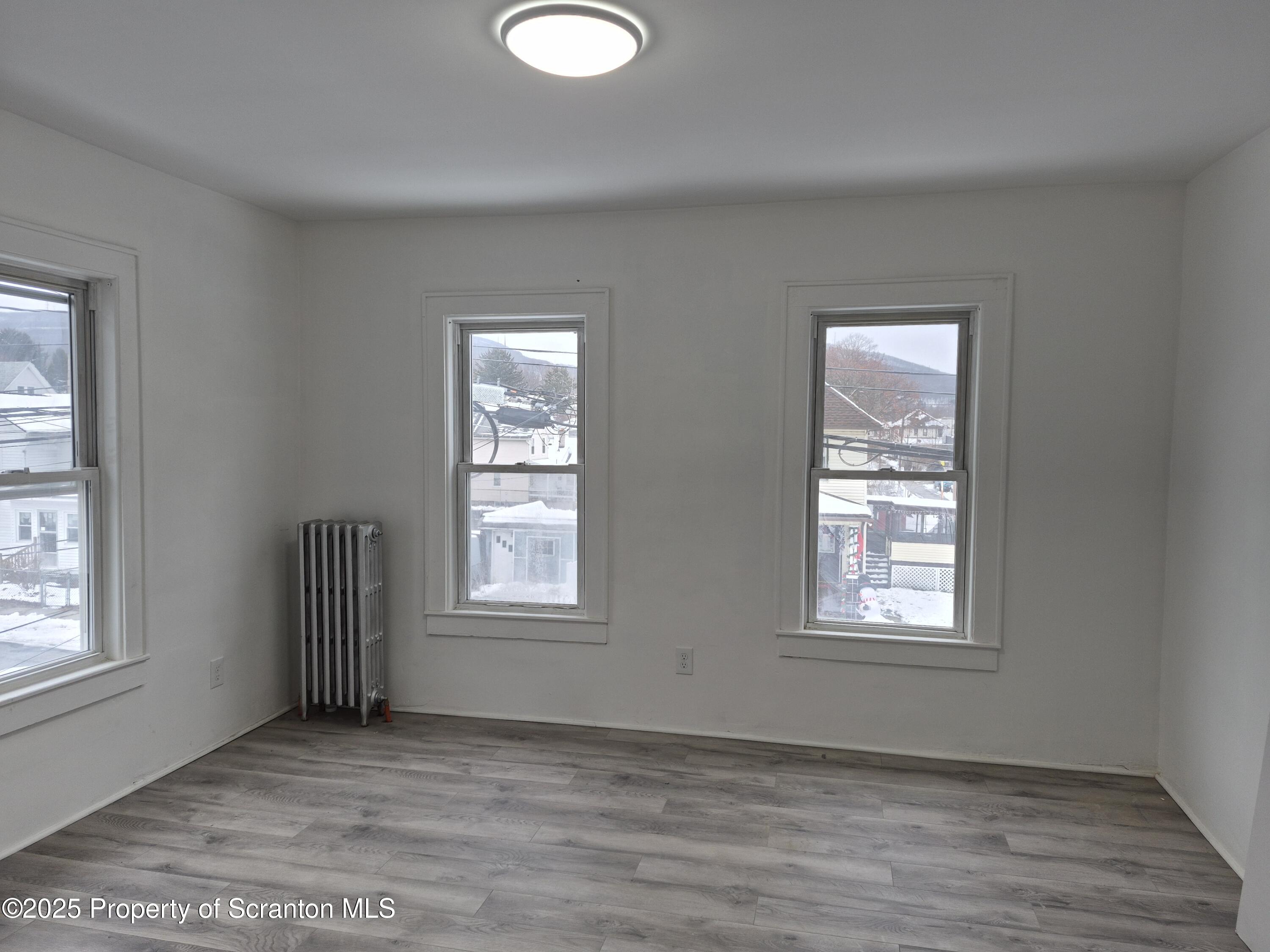 1758 Wayne Avenue Scranton, PA 18508 - Photo 10 of 20 an empty room with wooden floor and windows