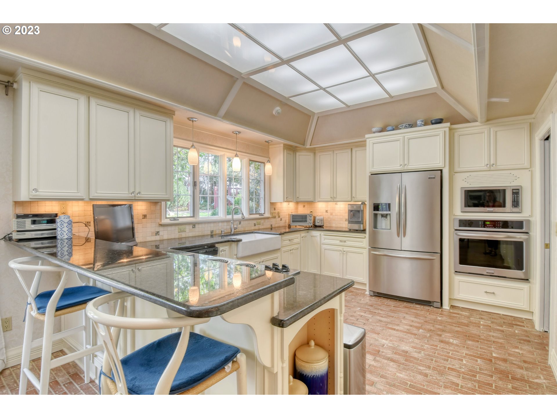 1092 Skyline Drive Pendleton, OR 97801 - Photo 19 of 47 a kitchen with stainless steel appliances granite countertop a refrigerator a sink dishwasher a stove with white cabinets and wooden floor