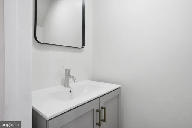 a bathroom with a sink and mirror