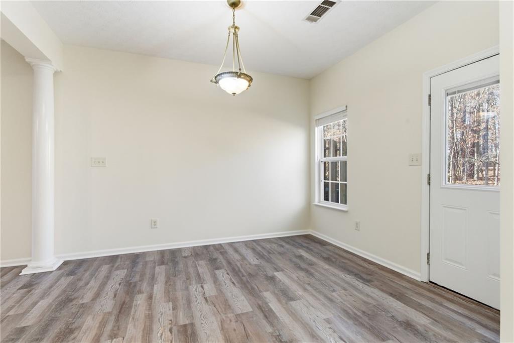 2913 Greyhawk Lane Cumming, GA 30040 - Photo 15 of 44 a view of an empty room with a window and wooden floor
