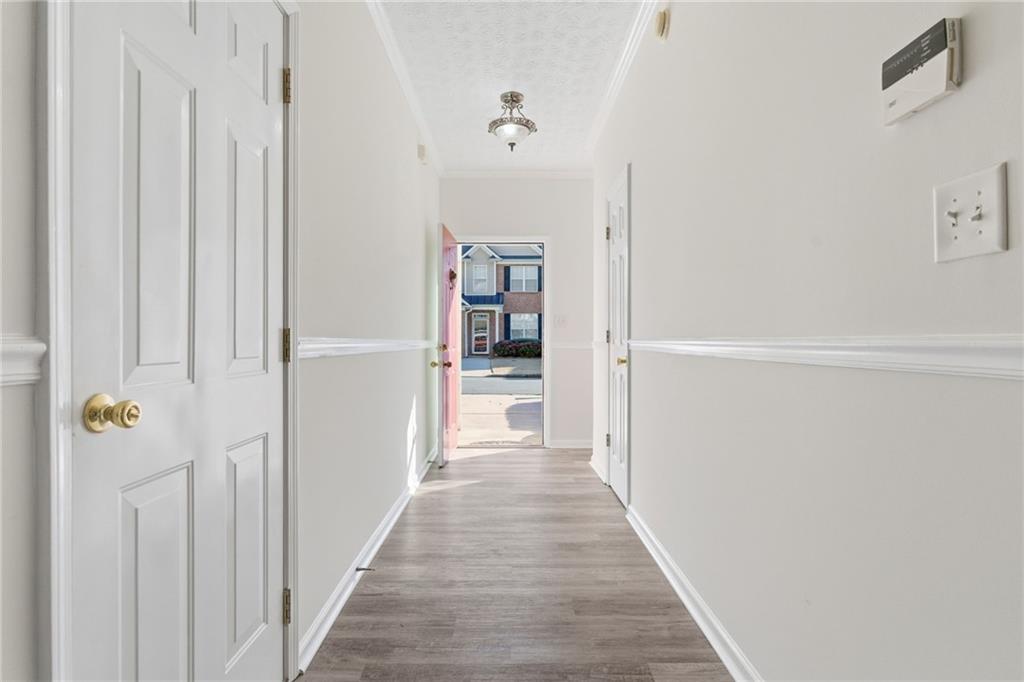 2913 Greyhawk Lane Cumming, GA 30040 - Photo 16 of 44 a view of a hallway with wooden floor and closet