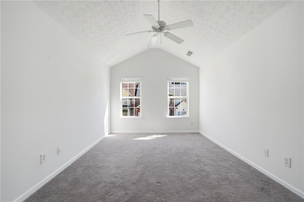 2913 Greyhawk Lane Cumming, GA 30040 - Photo 18 of 44 an empty room with windows and fan