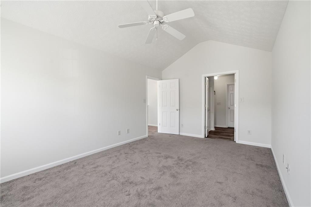 2913 Greyhawk Lane Cumming, GA 30040 - Photo 19 of 44 an empty room with fan and entryway