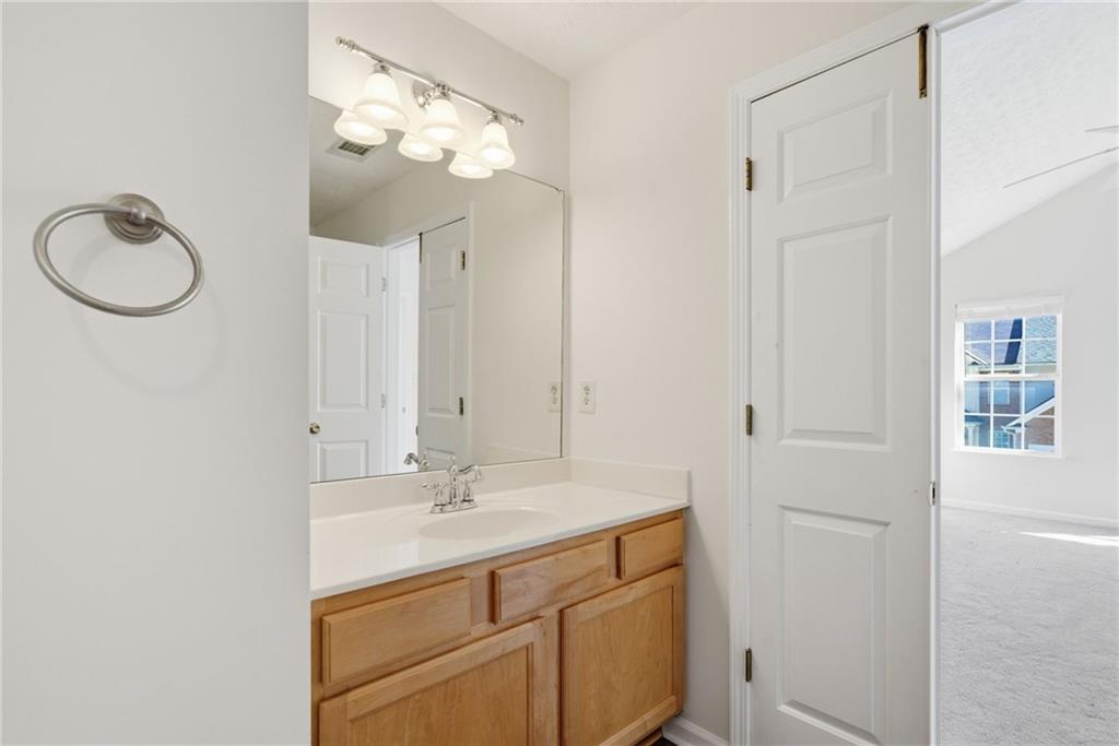 2913 Greyhawk Lane Cumming, GA 30040 - Photo 20 of 44 a bathroom with a sink a light fixture and a mirror
