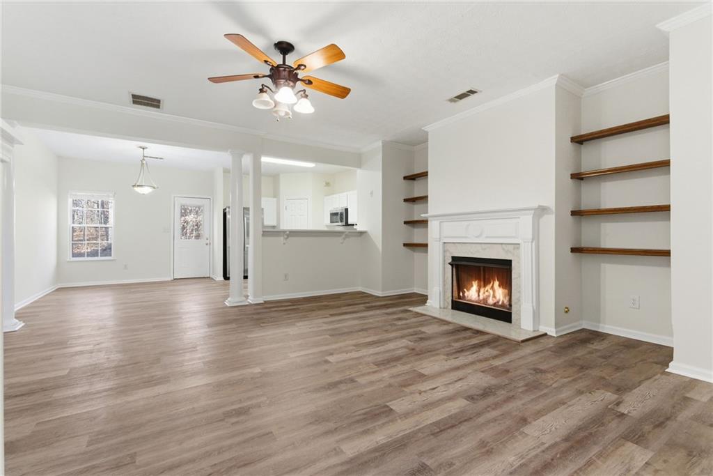 2913 Greyhawk Lane Cumming, GA 30040 - Photo 2 of 44 a view of an empty room with a fireplace and a window