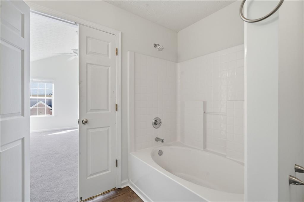 2913 Greyhawk Lane Cumming, GA 30040 - Photo 21 of 44 a bathroom with a bathtub and shower