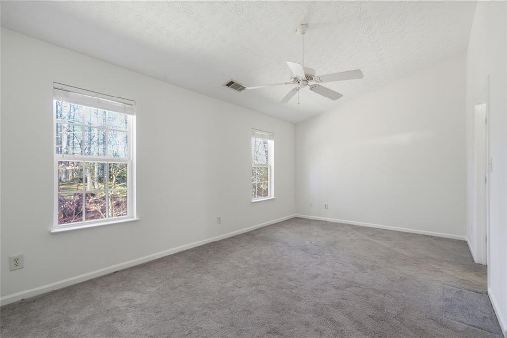 2913 Greyhawk Lane Cumming, GA 30040 - Photo 22 of 44 an empty room with windows and fan