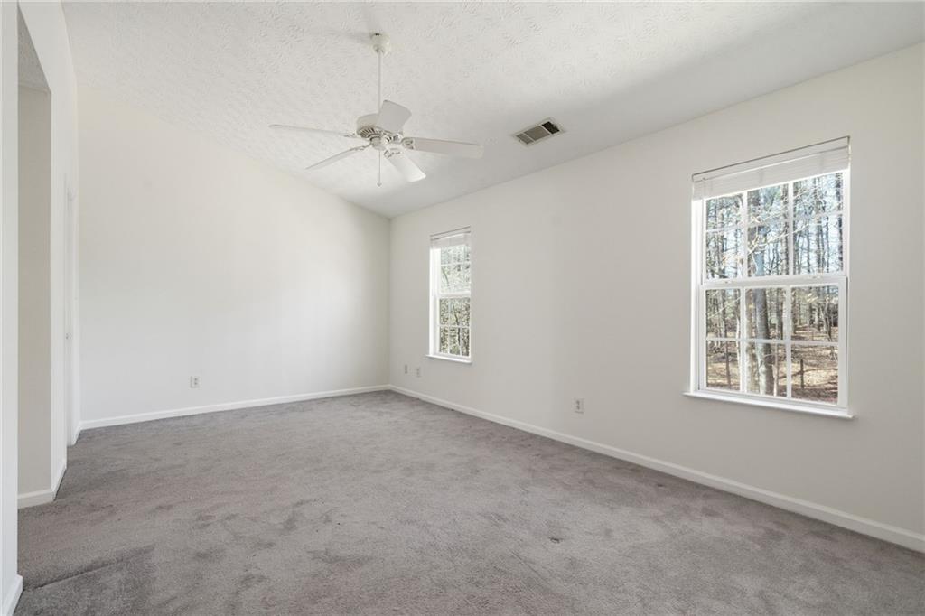 2913 Greyhawk Lane Cumming, GA 30040 - Photo 24 of 44 an empty room with windows and fan