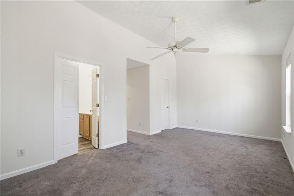 2913 Greyhawk Lane Cumming, GA 30040 - Photo 25 of 44 an empty room with closet and a ceiling fan