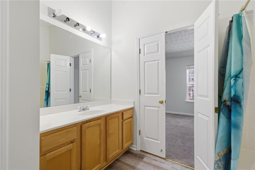 2913 Greyhawk Lane Cumming, GA 30040 - Photo 27 of 44 a bathroom with a sink and a mirror