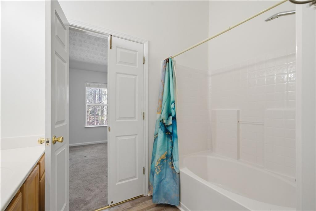 2913 Greyhawk Lane Cumming, GA 30040 - Photo 28 of 44 a bathroom with a bathtub and a shower