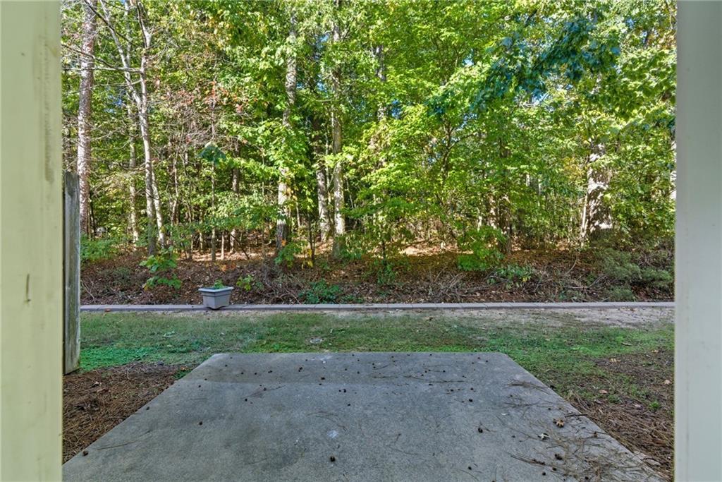 2913 Greyhawk Lane Cumming, GA 30040 - Photo 32 of 44 a backyard of a house with lots of green space and fountain