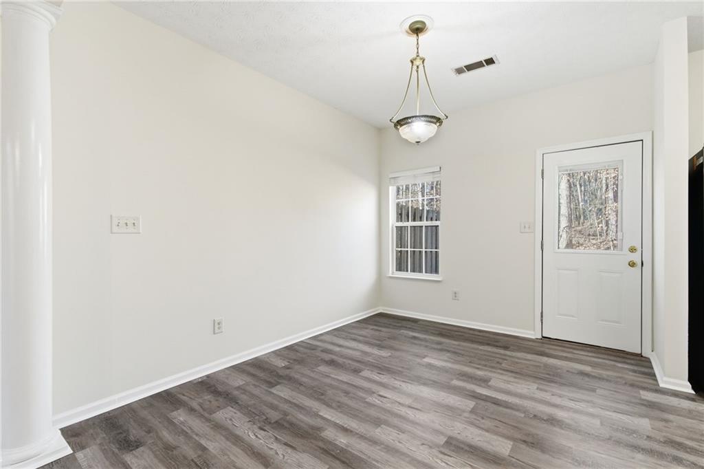 2913 Greyhawk Lane Cumming, GA 30040 - Photo 10 of 44 wooden floor in an empty room with a window