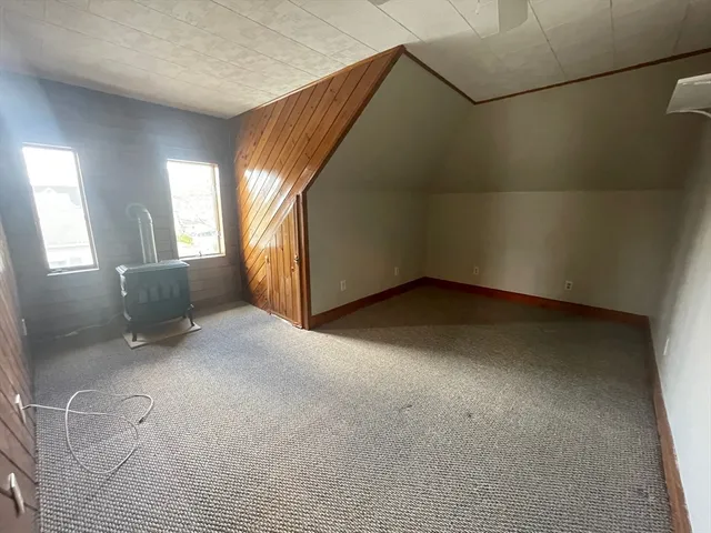 a view of a room with wooden walls and windows