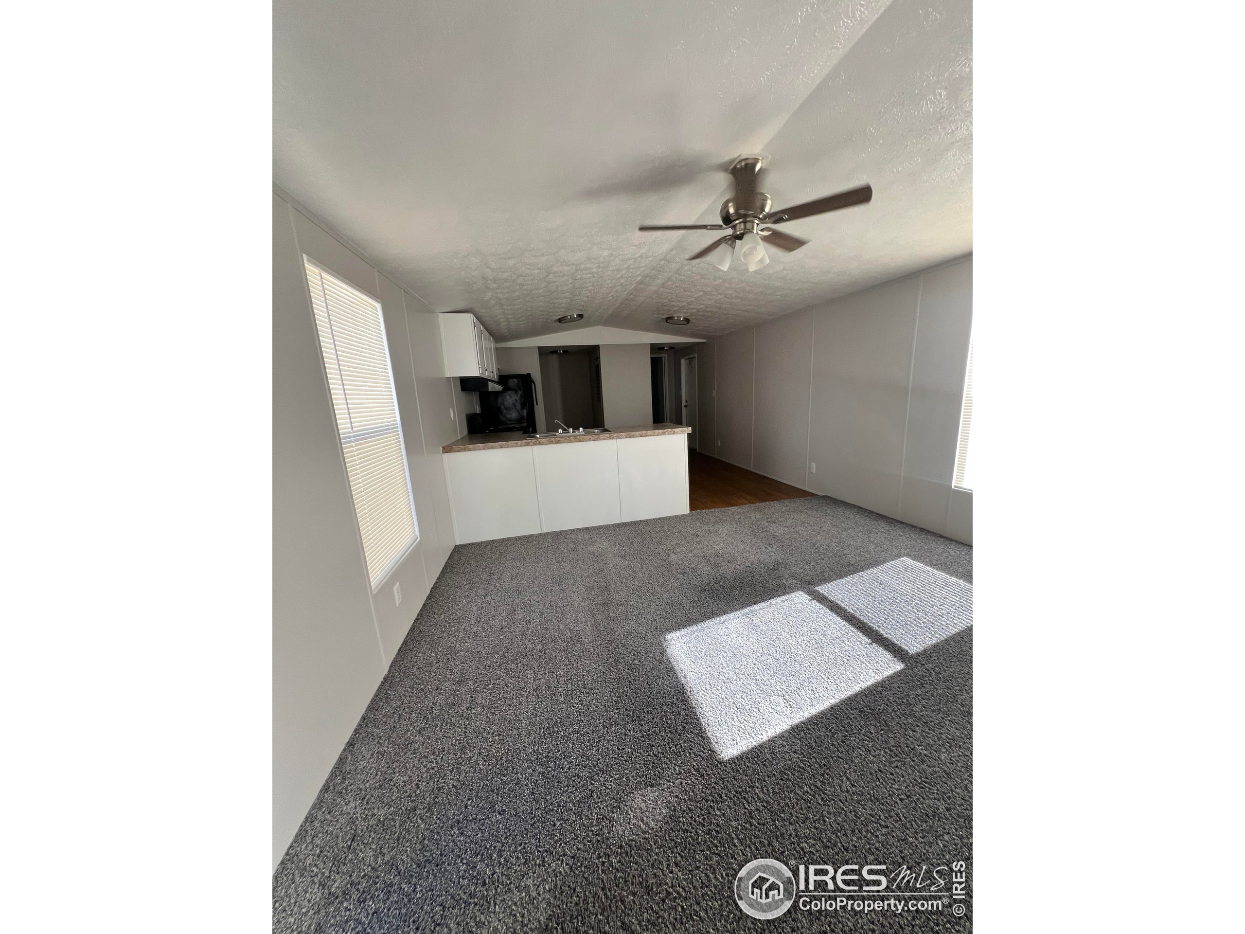 230 North 2nd Street, Unit 7 Berthoud, CO 80513 - Photo 5 of 14 a view of a hallway with a ceiling fan