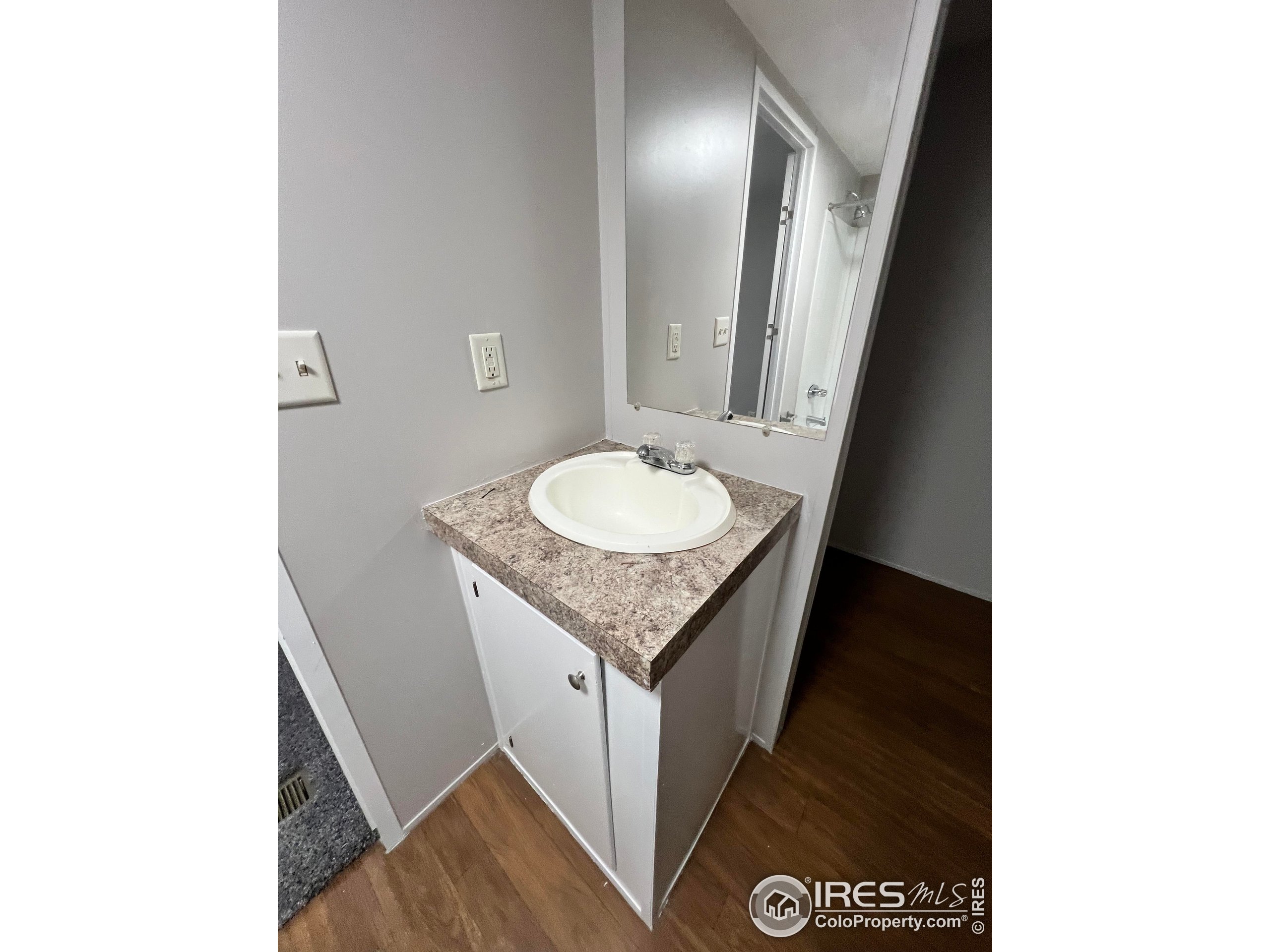 230 North 2nd Street, Unit 7 Berthoud, CO 80513 - Photo 9 of 14 a bathroom with a granite countertop sink and a mirror