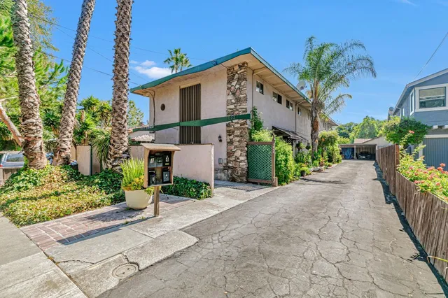 a front view of a house with a yard and a garage