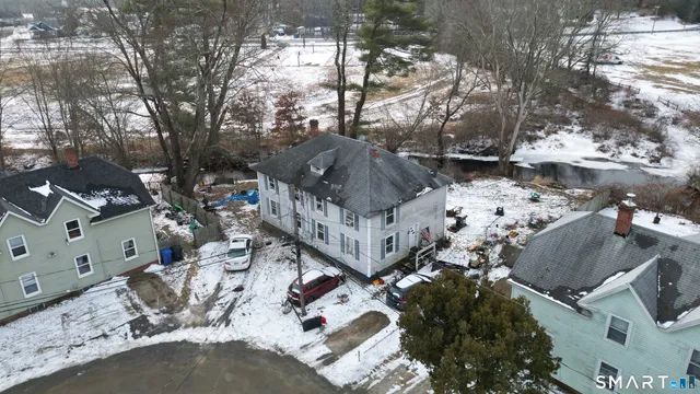 a front view of a house with cars parked