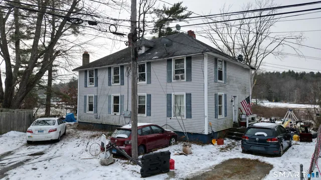 a car parked in front of a white house