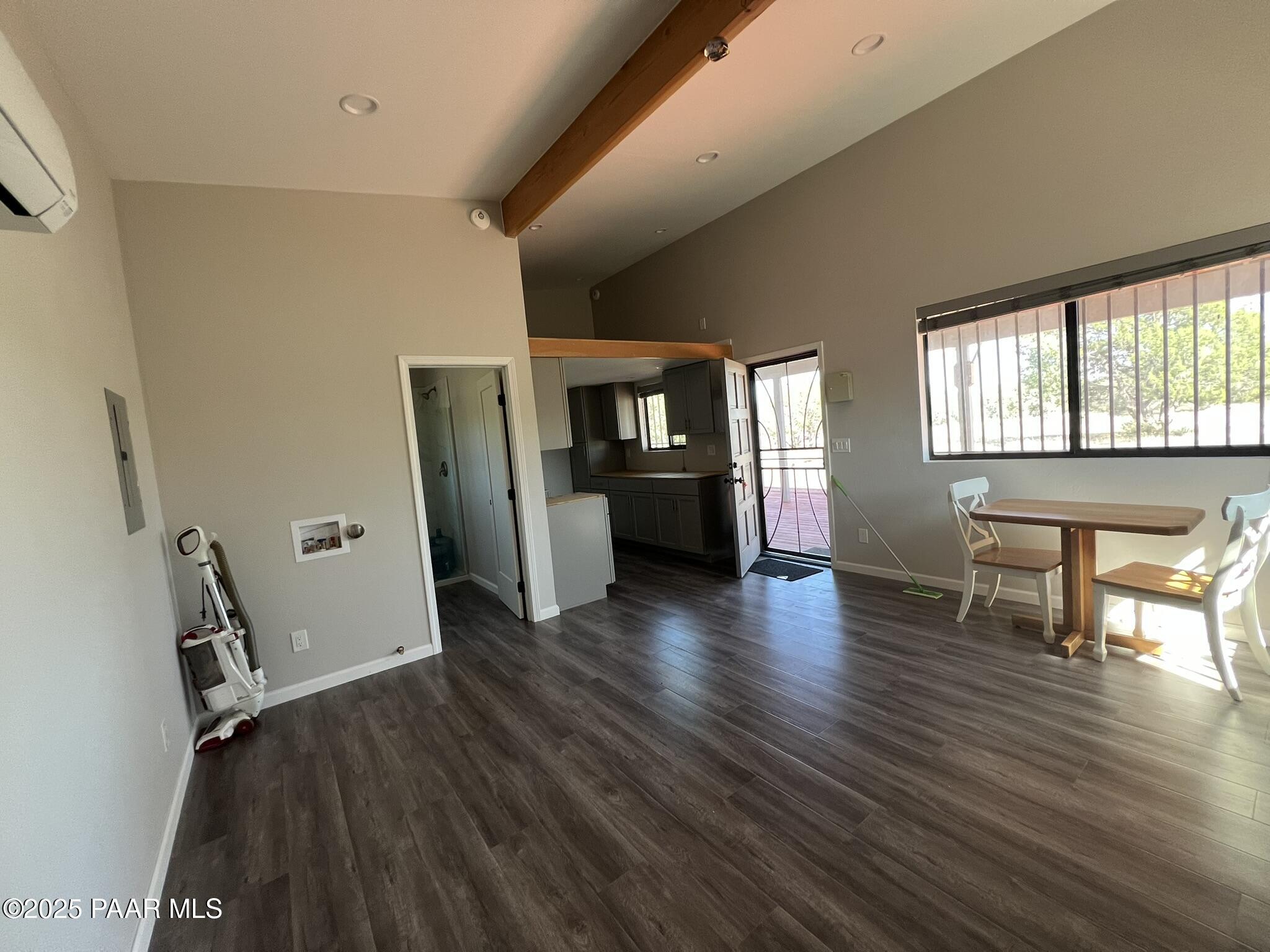 9188 Gleed Station Road Ash Fork, AZ 86320 - Photo 13 of 21 an empty room with wooden floor and windows