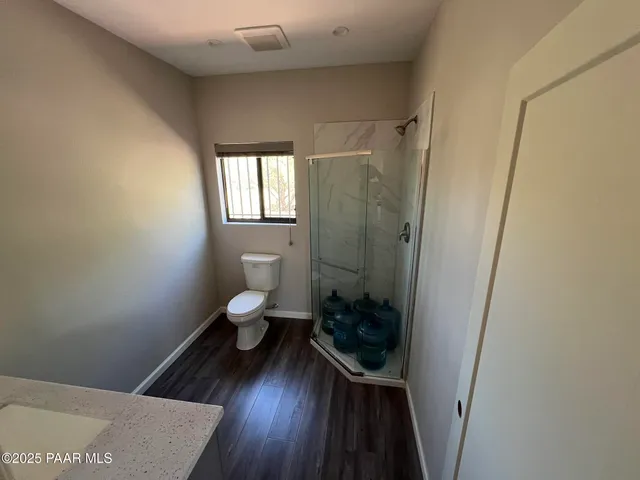 a bathroom with a toilet and a shower