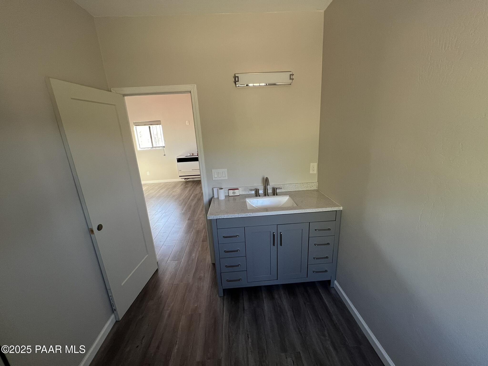 9188 Gleed Station Road Ash Fork, AZ 86320 - Photo 17 of 21 a bathroom with a sink a mirror and a toilet