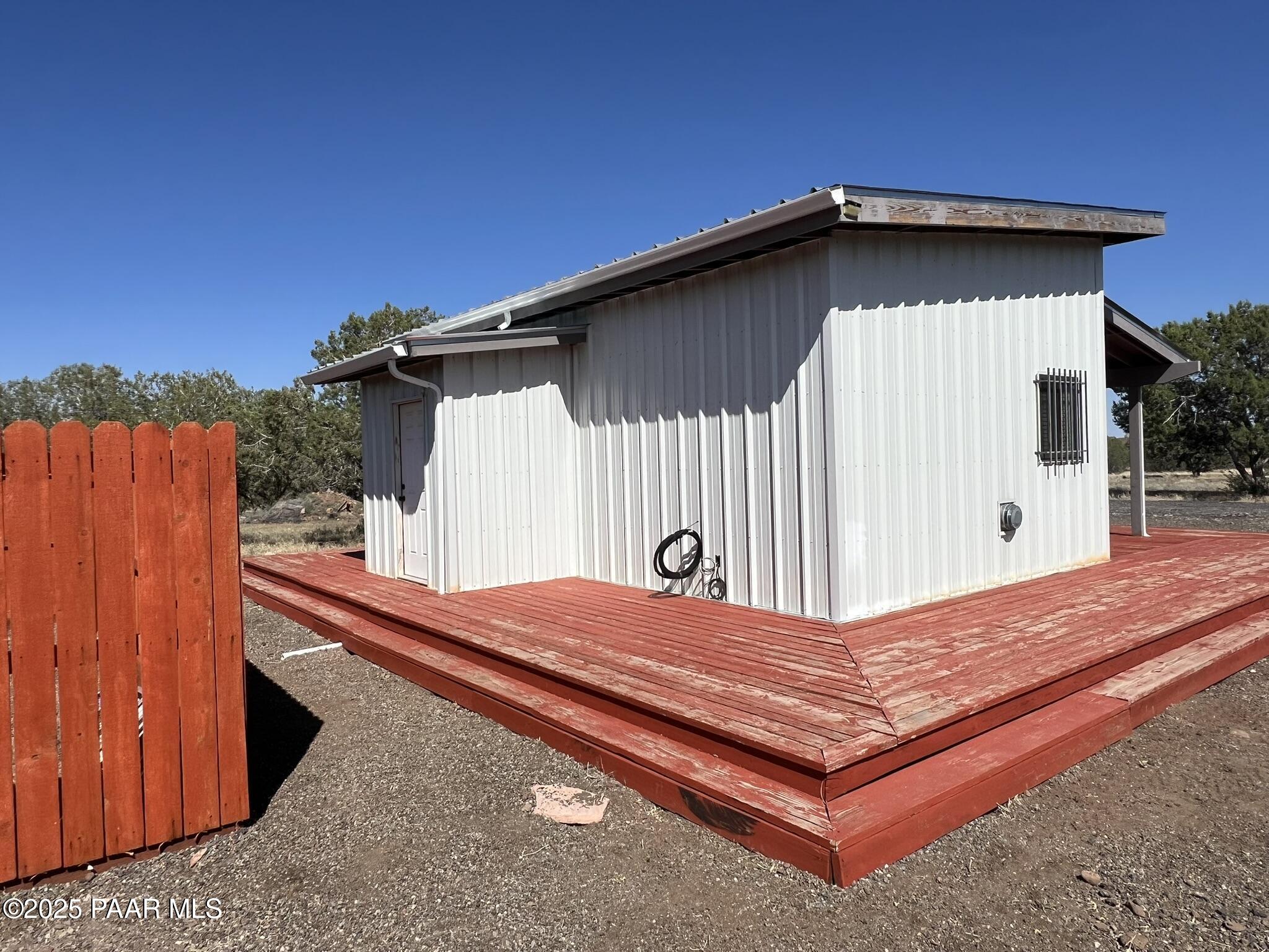 9188 Gleed Station Road Ash Fork, AZ 86320 - Photo 5 of 21 a backyard of a house with wooden fence table and chair