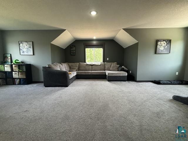 3454 Anderson Road Hibbing, MN 55746 - Photo 20 of 31 Spacious room featuring sloped ceilings, recessed lighting, and a prominent window