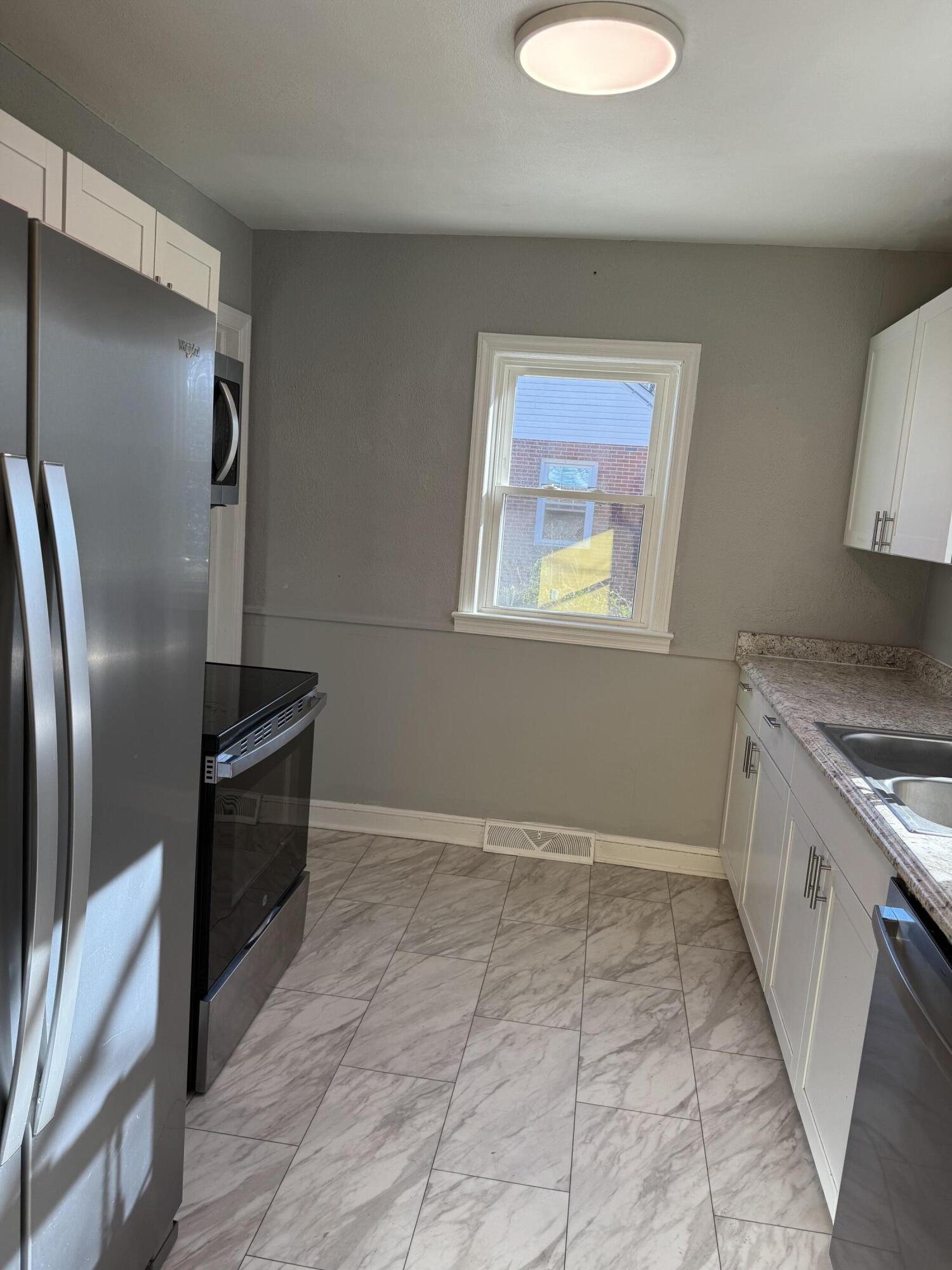509 Kessler Mill Road, Unit 509 Salem, VA 24153 - Photo 28 of 30 a kitchen with granite countertop a refrigerator and a stove