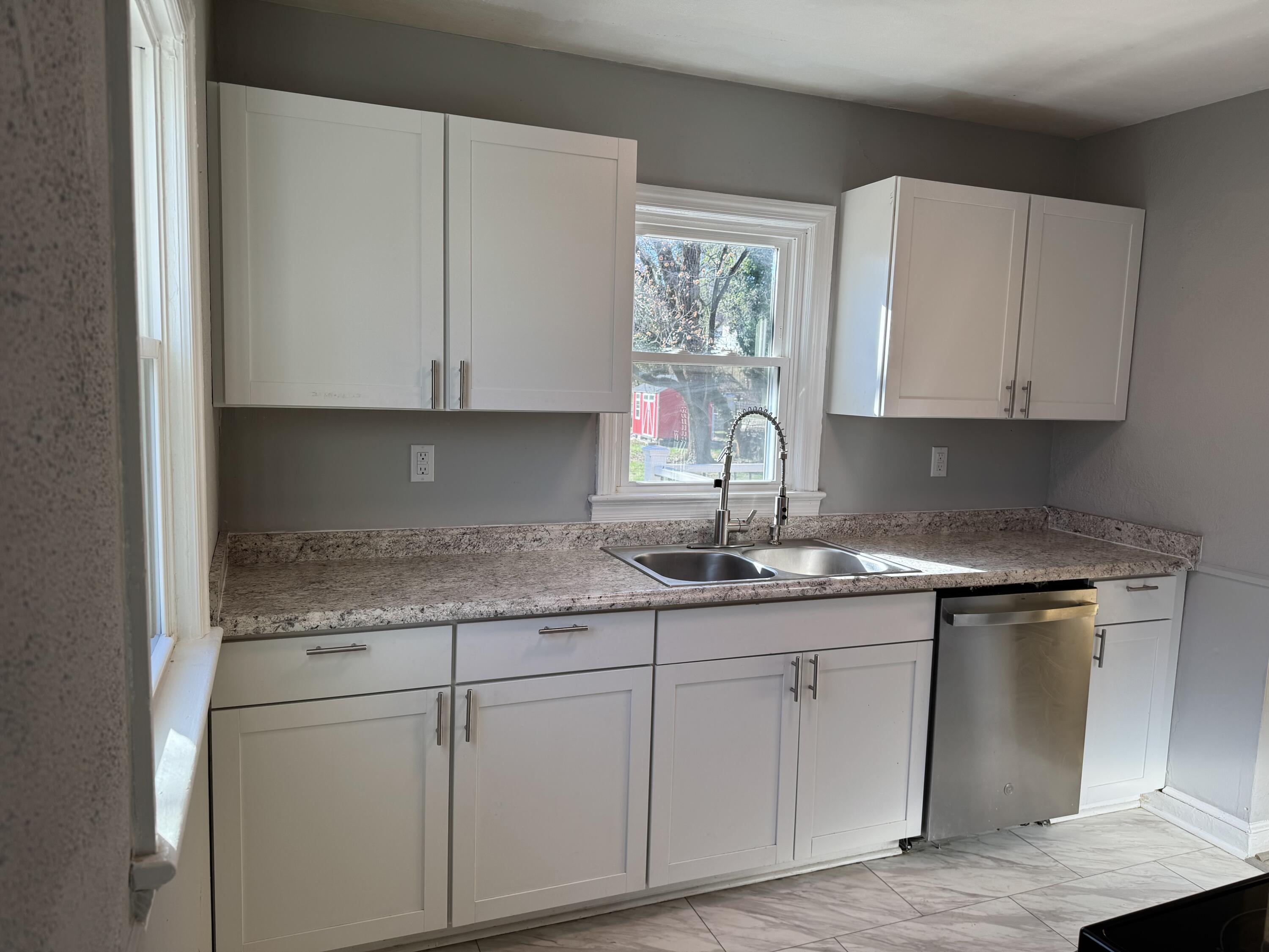 509 Kessler Mill Road, Unit 509 Salem, VA 24153 - Photo 6 of 30 a kitchen with granite countertop white cabinets and a sink