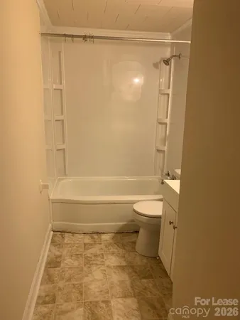 a bathroom with a toilet and shower